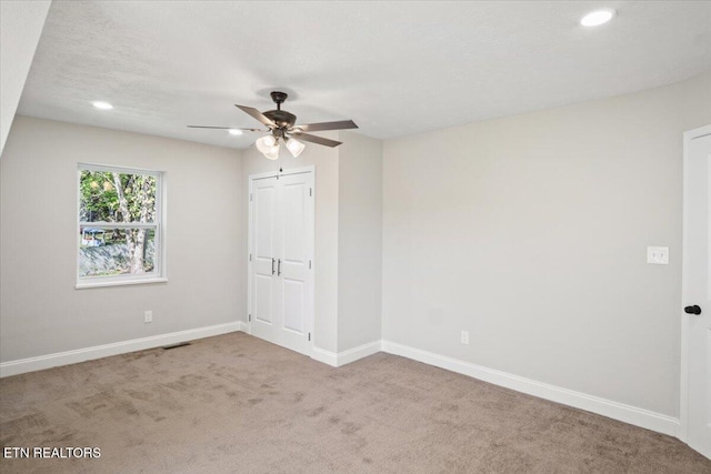 unfurnished bedroom with recessed lighting, carpet, visible vents, and baseboards