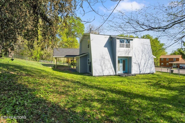 back of property featuring a yard and a fenced backyard