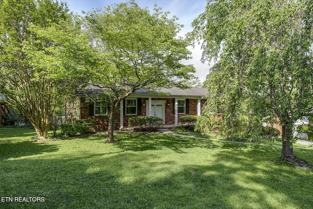 ranch-style house with brick siding and a front lawn