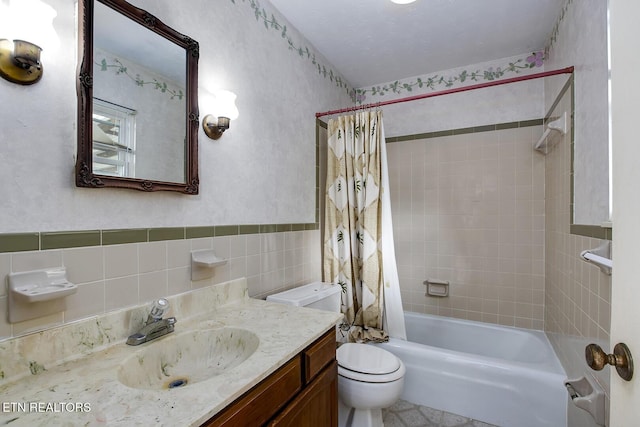full bathroom featuring vanity, toilet, tile walls, and shower / tub combo