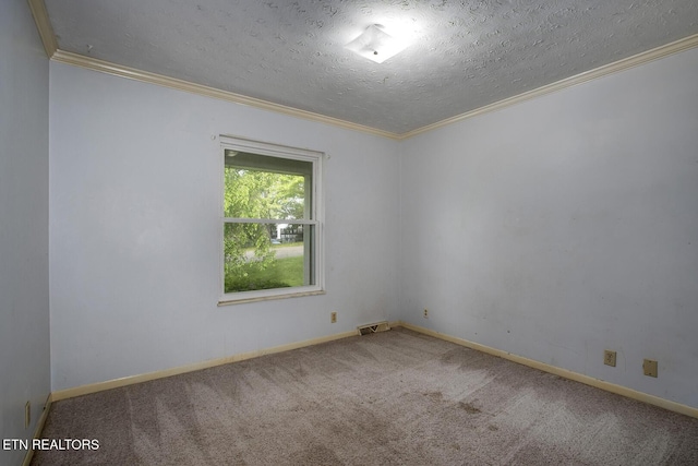 spare room with crown molding, carpet flooring, a textured ceiling, baseboards, and visible vents
