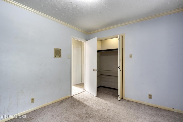 unfurnished bedroom featuring carpet floors, ornamental molding, and baseboards