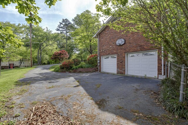 garage with aphalt driveway