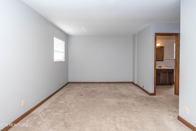 98 Hampshire Cir, Oak Ridge, TN 37830 - empty room featuring baseboards, light colored carpet, and a sink