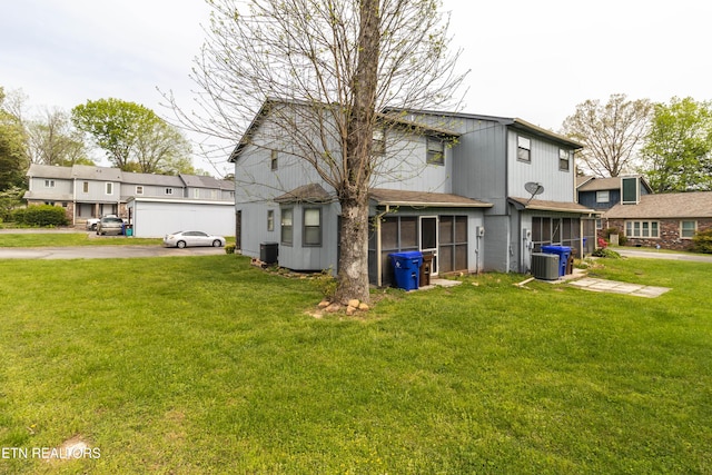 98 Hampshire Cir, Oak Ridge, TN 37830 - back of property featuring a sunroom, a yard, and cooling unit