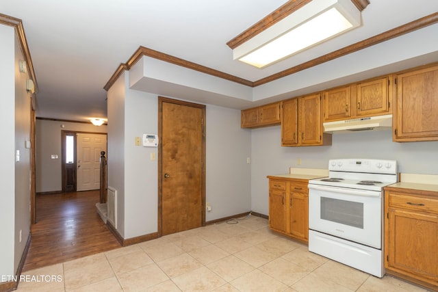 98 Hampshire Cir, Oak Ridge, TN 37830 - kitchen with crown molding, brown cabinetry, under cabinet range hood, and electric range
