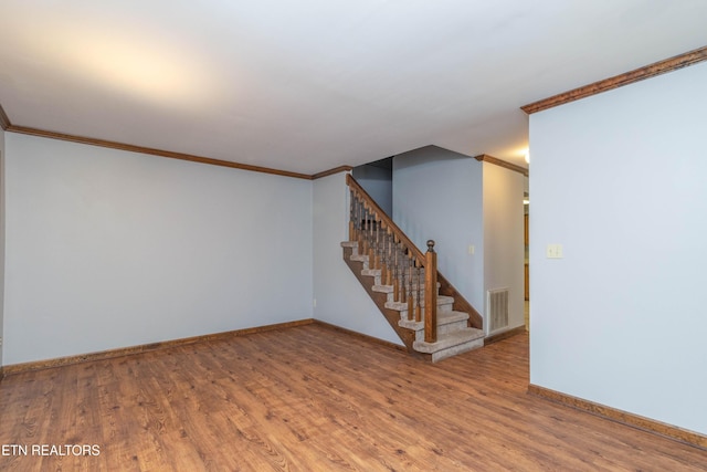 98 Hampshire Cir, Oak Ridge, TN 37830 - spare room with visible vents, baseboards, wood finished floors, and crown molding