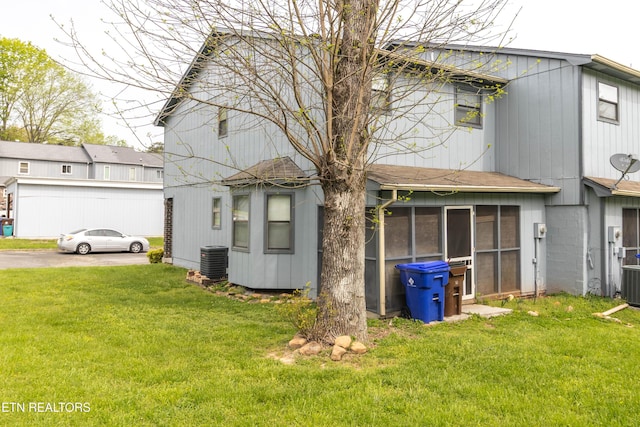 98 Hampshire Cir, Oak Ridge, TN 37830 - back of property with a sunroom, central AC unit, and a lawn