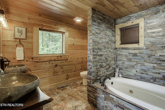 3505 Mountain Tyme Way, Sevierville, TN 37862 - bathroom with toilet, wood walls, stone finish floor, wooden ceiling, and a whirlpool tub