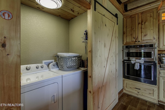 3505 Mountain Tyme Way, Sevierville, TN 37862 - clothes washing area featuring washing machine and dryer, dark wood-style flooring, a textured wall, and a barn door