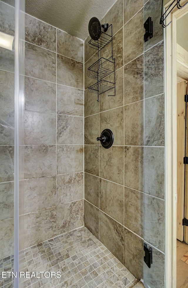 3505 Mountain Tyme Way, Sevierville, TN 37862 - bathroom with a textured ceiling and a tile shower