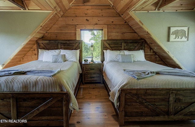 3505 Mountain Tyme Way, Sevierville, TN 37862 - bedroom featuring vaulted ceiling, wooden walls, and hardwood / wood-style floors