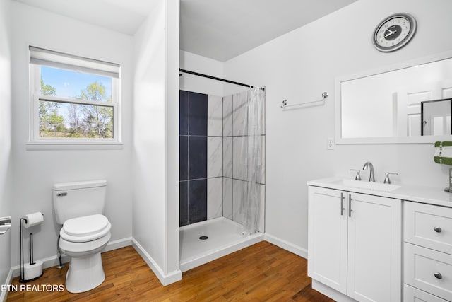 139 Hearon Rd, Kingston, TN 37763 - full bath with baseboards, toilet, a tile shower, vanity, and wood finished floors