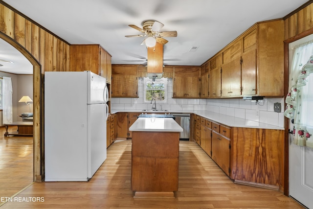 139 Hearon Rd, Kingston, TN 37763 - kitchen with light wood-style flooring, brown cabinets, freestanding refrigerator, and ceiling fan