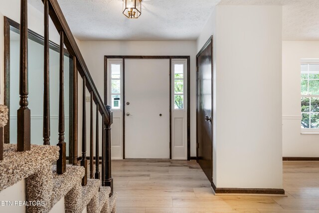1104 Burning Tree Ln, Knoxville, TN 37923 - foyer entrance featuring light wood finished floors, stairway, a textured ceiling, and baseboards