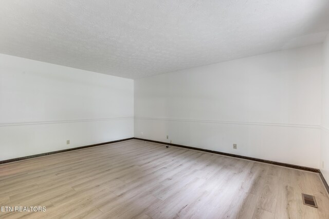 1104 Burning Tree Ln, Knoxville, TN 37923 - empty room featuring wood finished floors, baseboards, and a textured ceiling