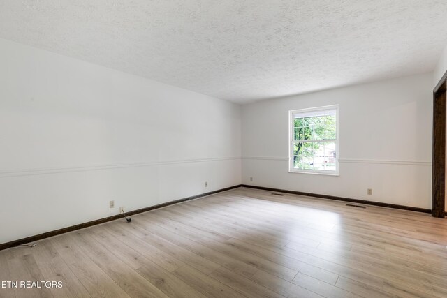 1104 Burning Tree Ln, Knoxville, TN 37923 - empty room with a textured ceiling, wood finished floors, and baseboards