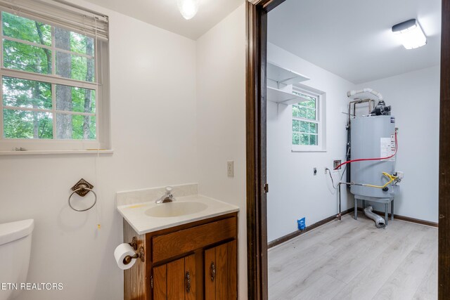 1104 Burning Tree Ln, Knoxville, TN 37923 - bathroom featuring gas water heater, toilet, wood finished floors, vanity, and baseboards