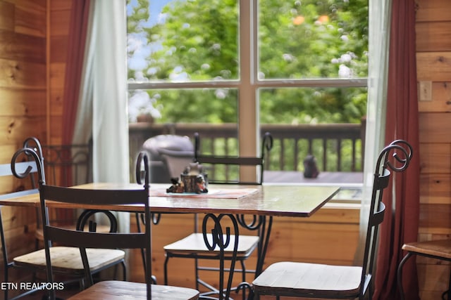dining room with wooden walls