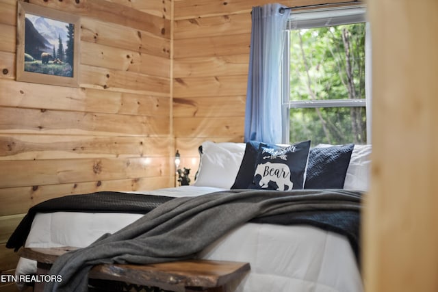 bedroom with wooden walls