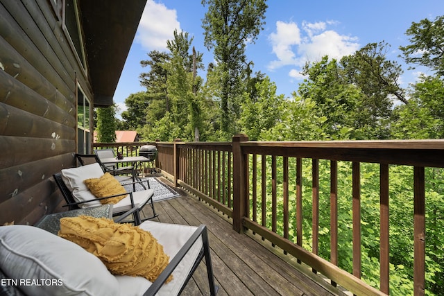 deck featuring outdoor dining space and a grill