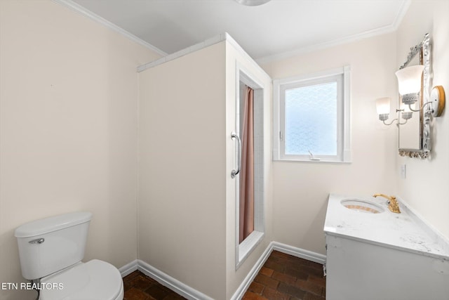 bathroom featuring toilet, ornamental molding, baseboards, and vanity