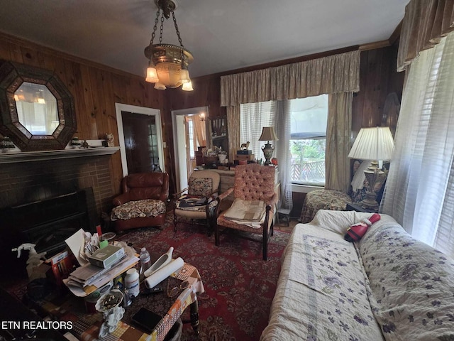 1000 Biddle St, Knoxville, TN 37914 - living room with a brick fireplace, wood walls, ornamental molding, and a healthy amount of sunlight