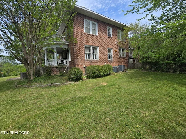 1000 Biddle St, Knoxville, TN 37914 - rear view of property featuring central AC unit, brick siding, a yard, and covered porch
