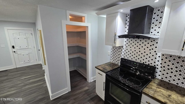 101 Old Vasper Rd, Caryville, TN 37714 - kitchen with tasteful backsplash, dark wood-style floors, white cabinetry, electric range, and wall chimney exhaust hood