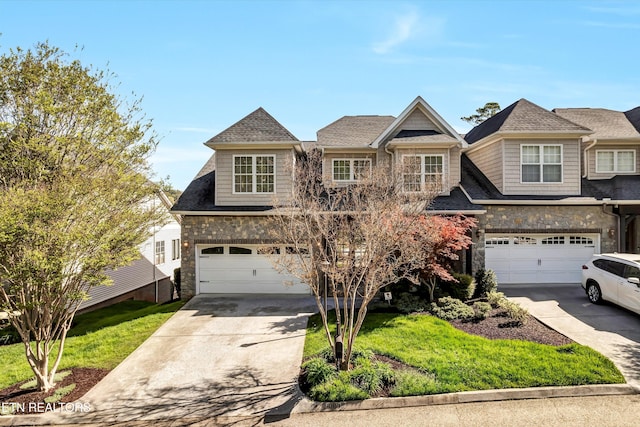 10033 Autumn Valley Ln, Knoxville, TN 37922 - view of front facade with roof with shingles, driveway, stone siding, and an attached garage