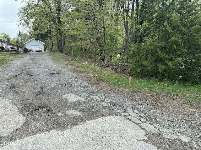 view of street featuring gravel driveway