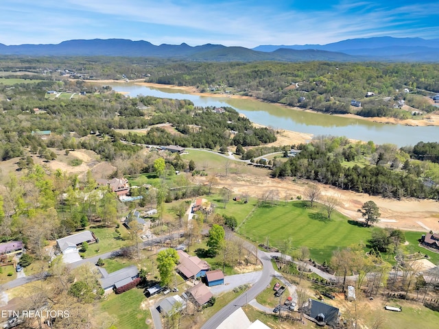 aerial view with a view of trees and a water and mountain view