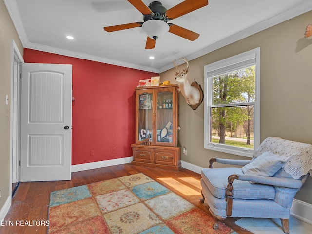 sitting room featuring wood finished floors, baseboards, ornamental molding, and recessed lighting