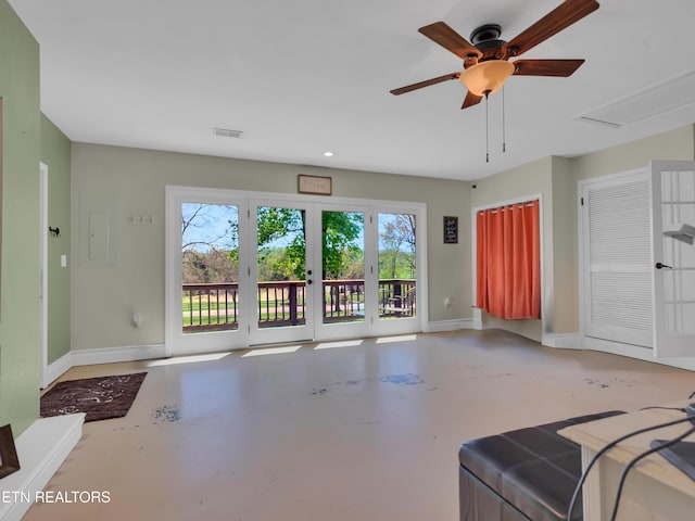 unfurnished living room with concrete flooring, visible vents, baseboards, and a ceiling fan