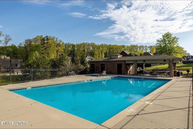 pool with fence and a patio area