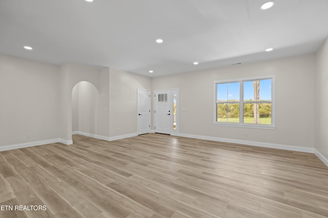 322 Fairway Dr, Dandridge, TN 37725 - unfurnished living room featuring arched walkways, light wood-style floors, baseboards, and recessed lighting