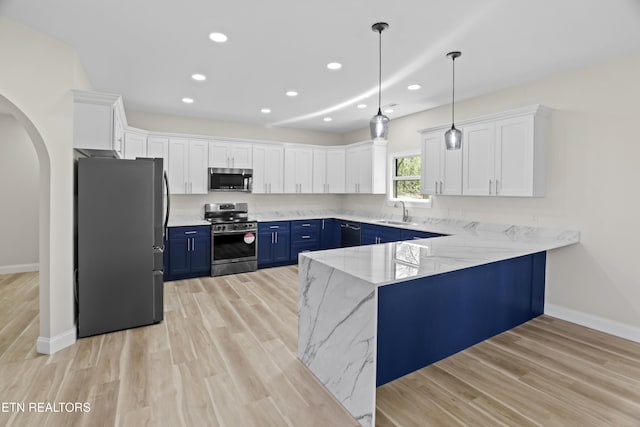 322 Fairway Dr, Dandridge, TN 37725 - kitchen with arched walkways, a sink, appliances with stainless steel finishes, a peninsula, and blue cabinetry