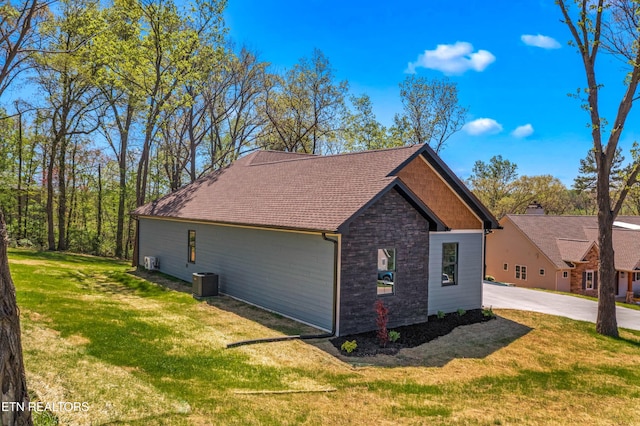 322 Fairway Dr, Dandridge, TN 37725 - view of side of property with central air condition unit, stone siding, and a lawn