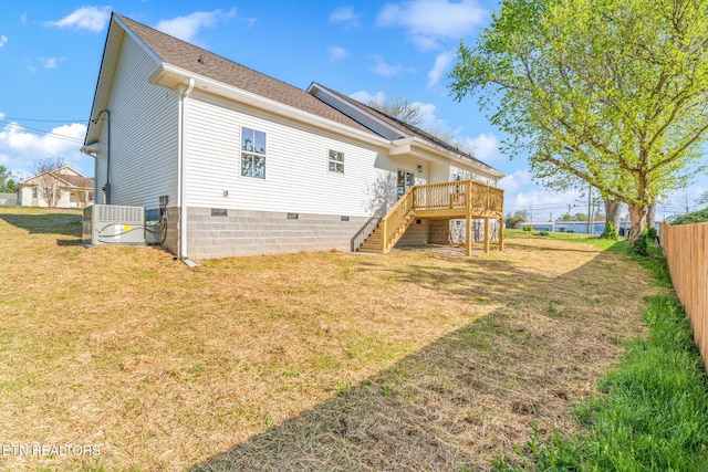 back of property featuring a lawn, crawl space, fence, stairs, and a wooden deck