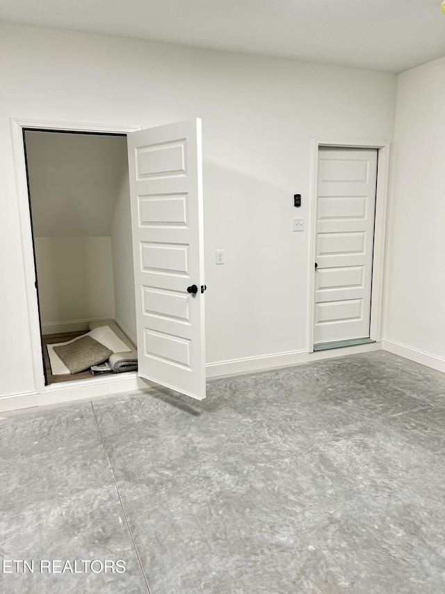 spare room with baseboards