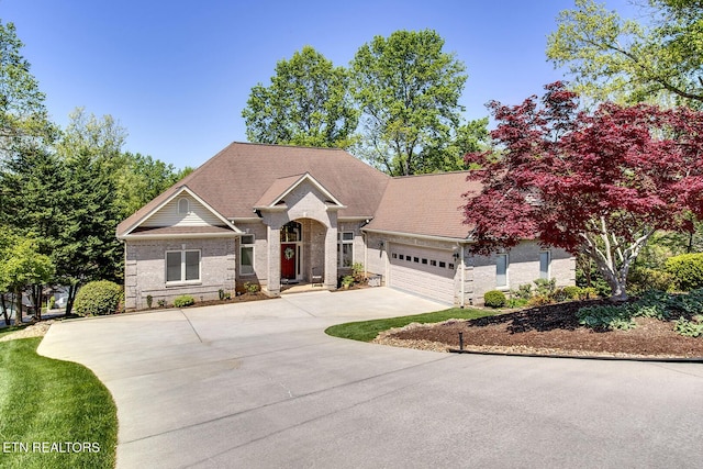 405 Tecumseh Pt, Loudon, TN 37774 - ranch-style house with brick siding, an attached garage, a shingled roof, and concrete driveway