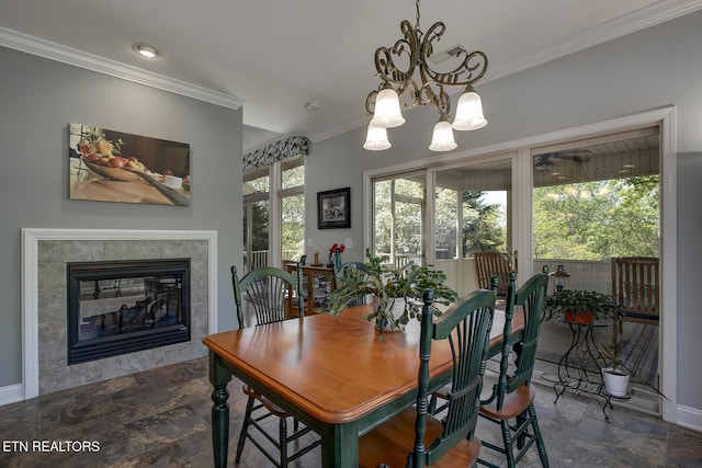 405 Tecumseh Pt, Loudon, TN 37774 - dining room with stone finish floor, crown molding, baseboards, and an inviting chandelier