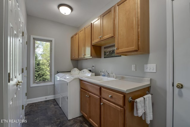 405 Tecumseh Pt, Loudon, TN 37774 - washroom featuring washer and clothes dryer, baseboards, cabinet space, and a sink