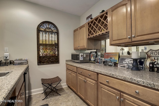 405 Tecumseh Pt, Loudon, TN 37774 - kitchen with brown cabinetry, baseboards, a sink, and appliances with stainless steel finishes
