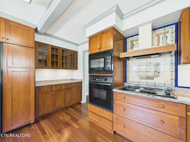 kitchen featuring glass insert cabinets, ornamental molding, dark wood finished floors, brown cabinetry, and black appliances