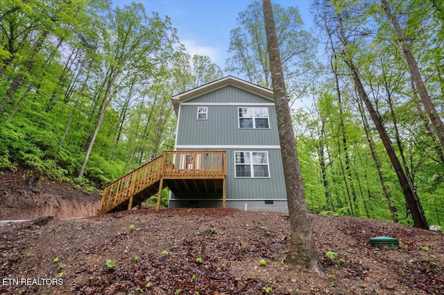 back of house featuring a deck, stairway, and crawl space