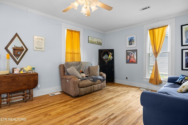 207 Loomis St, Tellico Plains, TN 37385 - living area featuring baseboards, light wood-style flooring, crown molding, visible vents, and ceiling fan