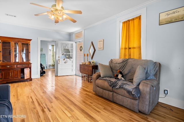 207 Loomis St, Tellico Plains, TN 37385 - living area featuring crown molding, light wood-style flooring, a ceiling fan, visible vents, and baseboards