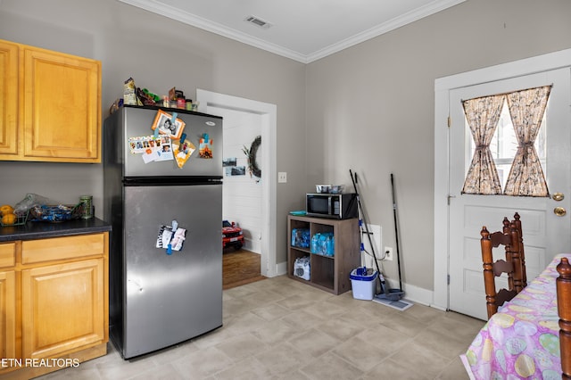 207 Loomis St, Tellico Plains, TN 37385 - kitchen featuring crown molding, visible vents, dark countertops, stainless steel appliances, and baseboards