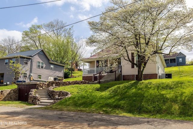 207 Loomis St, Tellico Plains, TN 37385 - view of front of property with a front lawn, covered porch, and stairs